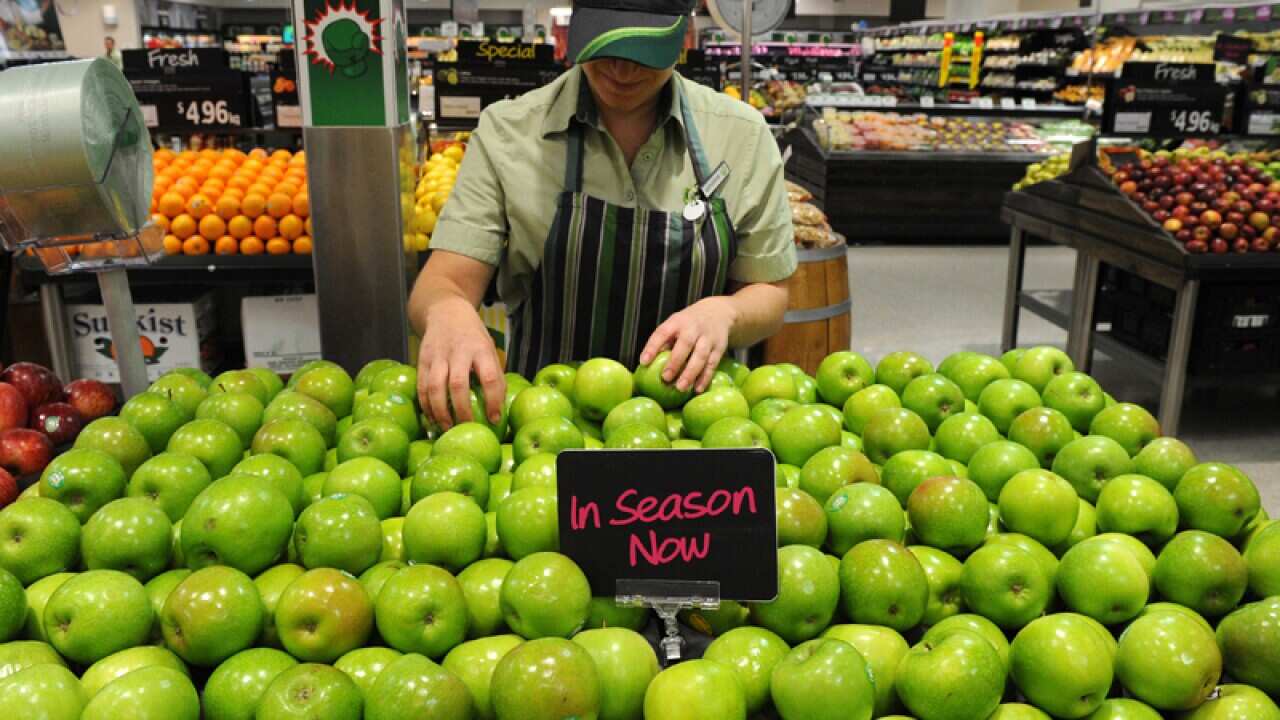 An employee inside a Woolworths grocery store in Brisbane
