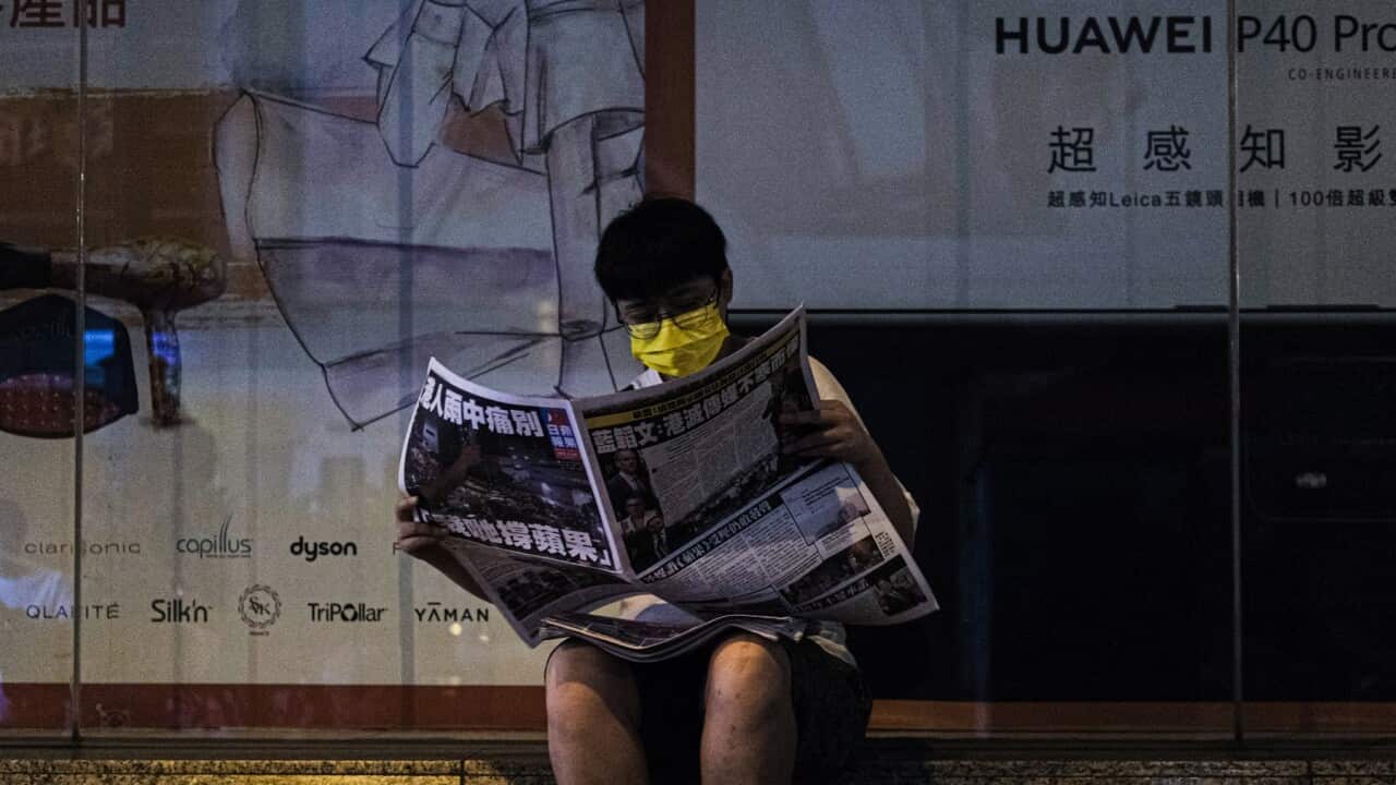 A Hong Konger reads the final edition of the Apple Daily newspaper