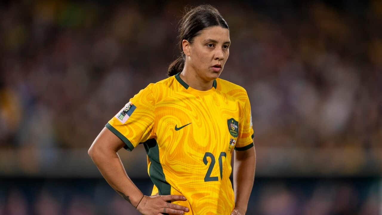A woman wearing a green and yellow jersey.
