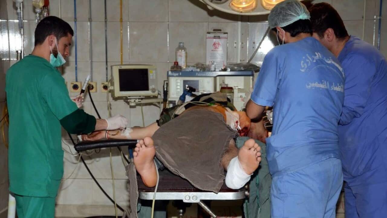 Doctors operating on an injured civilian at a hospital in Aleppo