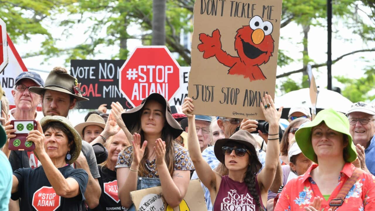 Protesters at a Stop Adani rally in Brisbane, Monday, April 22, 2019. Conservationist and former Greens leader Bob Brown has led a march on the Adani HQ to protest their proposed mine in the Galilee Basin. (AAP Image/Dave Hunt) NO ARCHIVING