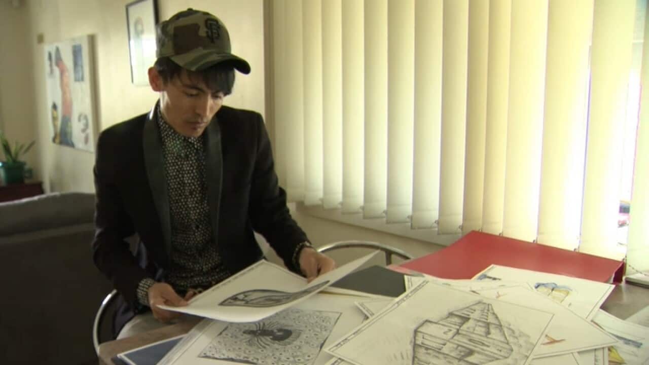 Yousuf Karimi going through his architecture drawings
