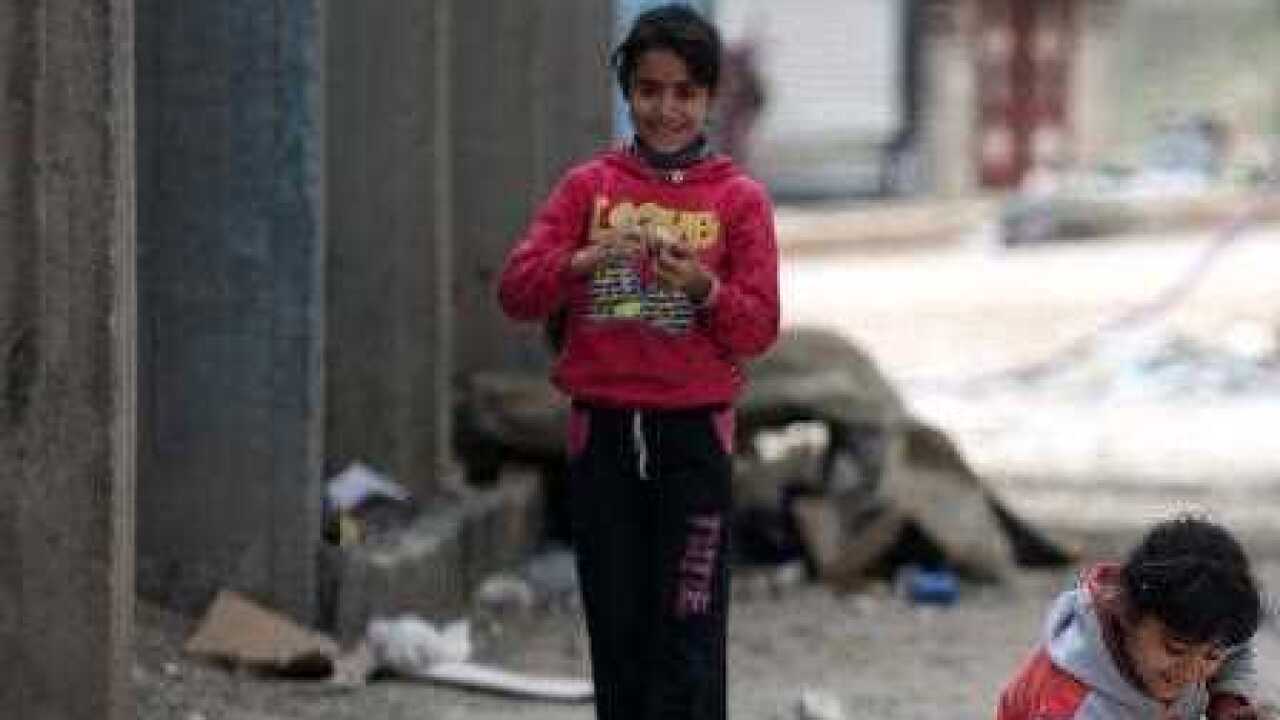 Children play at the recently captured city of Afrin, Syria,