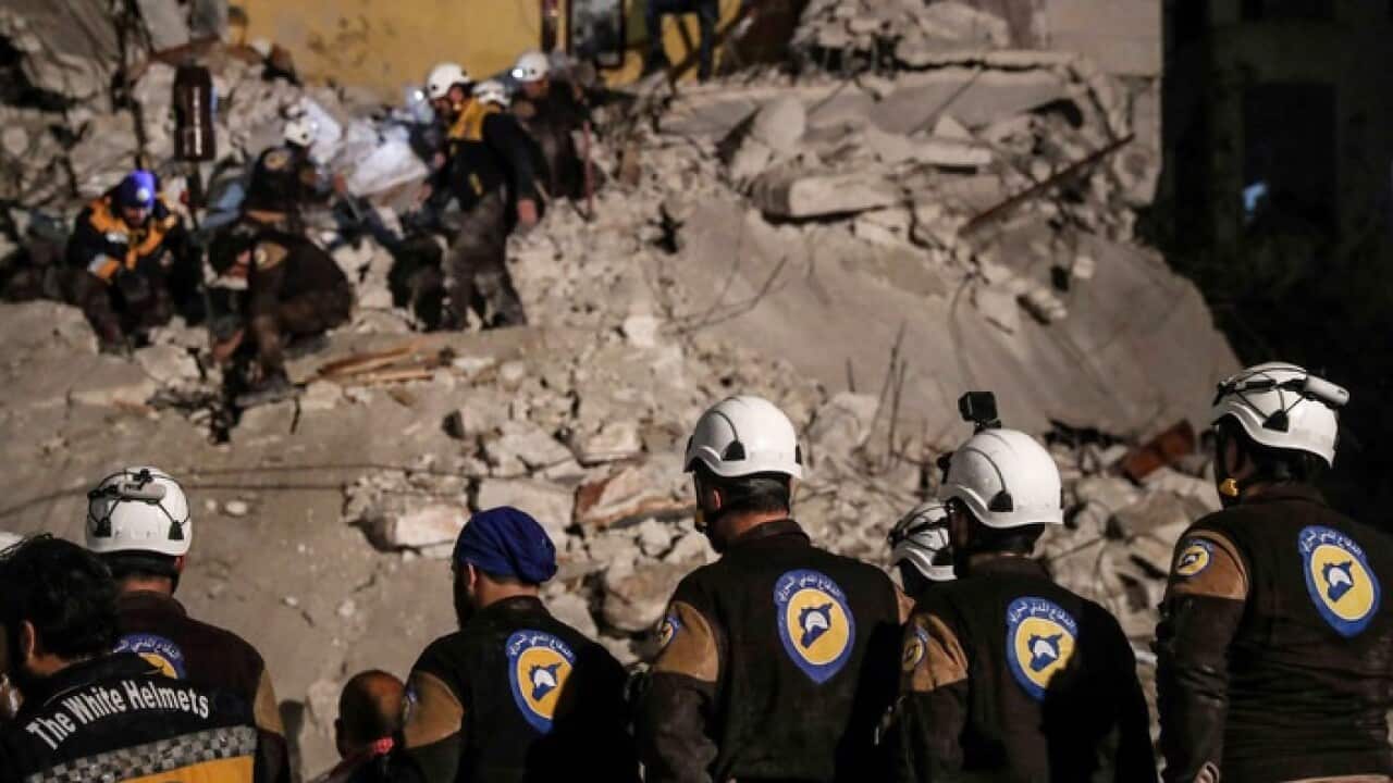 White Helmets volunteers search for survivors after an explosion in the city of Idlib, Syria, in April