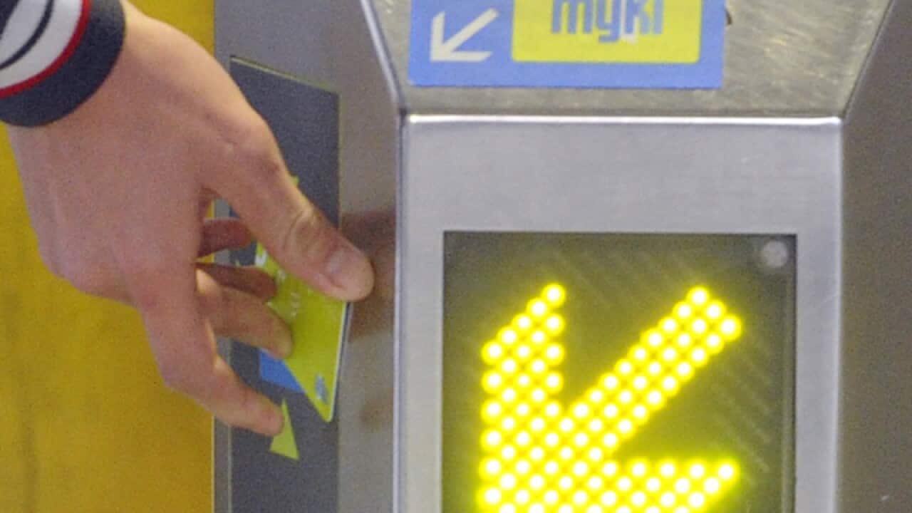 A public transport user swipes a MYKI card