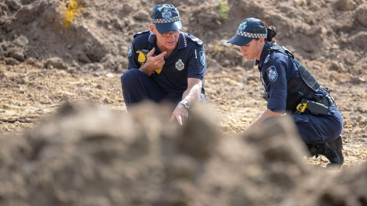 Police are seen scouring dug up earth near Morayfield road in Burpengary, north of Brisbane.