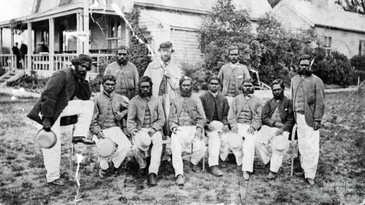 Photograph of the first Aboriginal cricket team with coach and captain Tom Wills outside the MCC pavilion of the Melbourne Cricket Ground.
