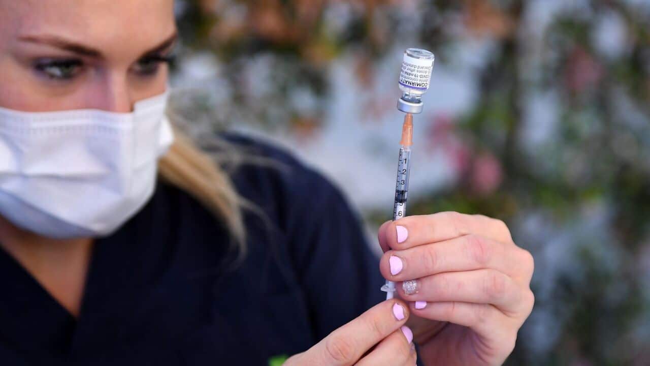 Nurse preparing a COVID-19 vaccine. Source: AAP Image/Albert Perez