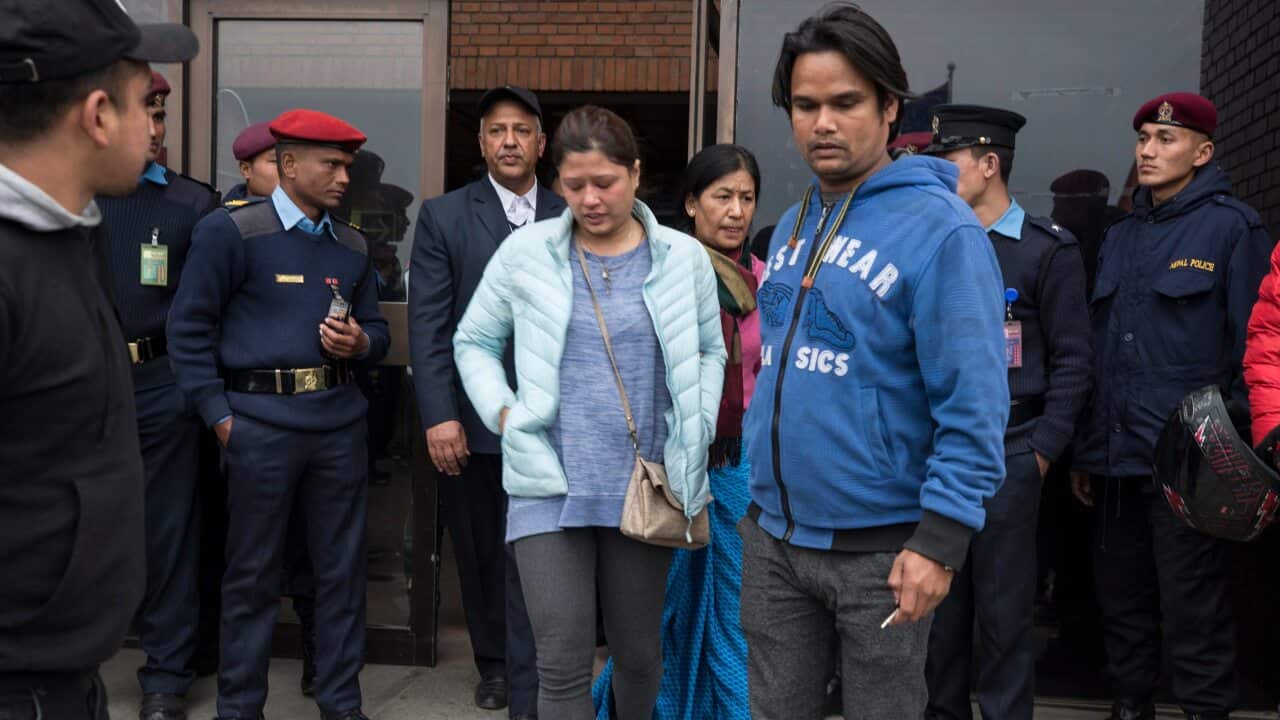 Family members of helicopter crash victims mourn at the International airport in Kathmandu, Nepal.