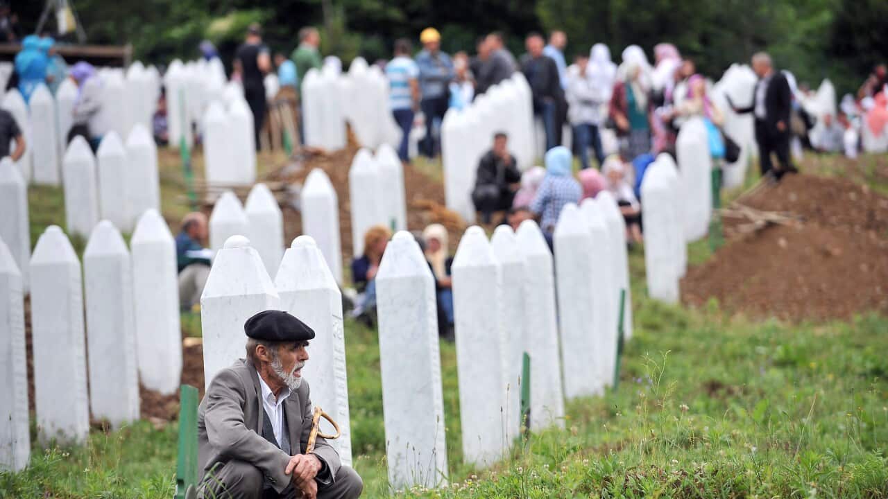 A Bosnian Muslim man, survivor of the 1995 Srebrenica massacre, pays his respects at Srebrenica-Potocari Genocide Memorial cemetery. (Getty)