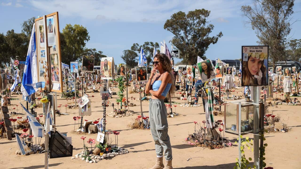 A woman looks at pictures and memorials for Israeli festival goers who killed by Hamas at the site of the Supernova Music Festival rave near Kibbutz Reim, Southern Israel, 19 September 2024.