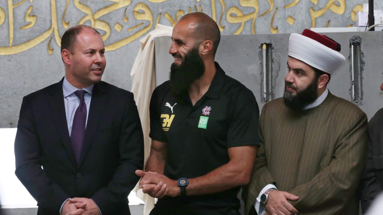 Treasurer Josh Frydenberg speaks with AFL player Bachar Houli during a visit to the Australian Islamic Centre in Melbourne, Friday, February 14, 2020.