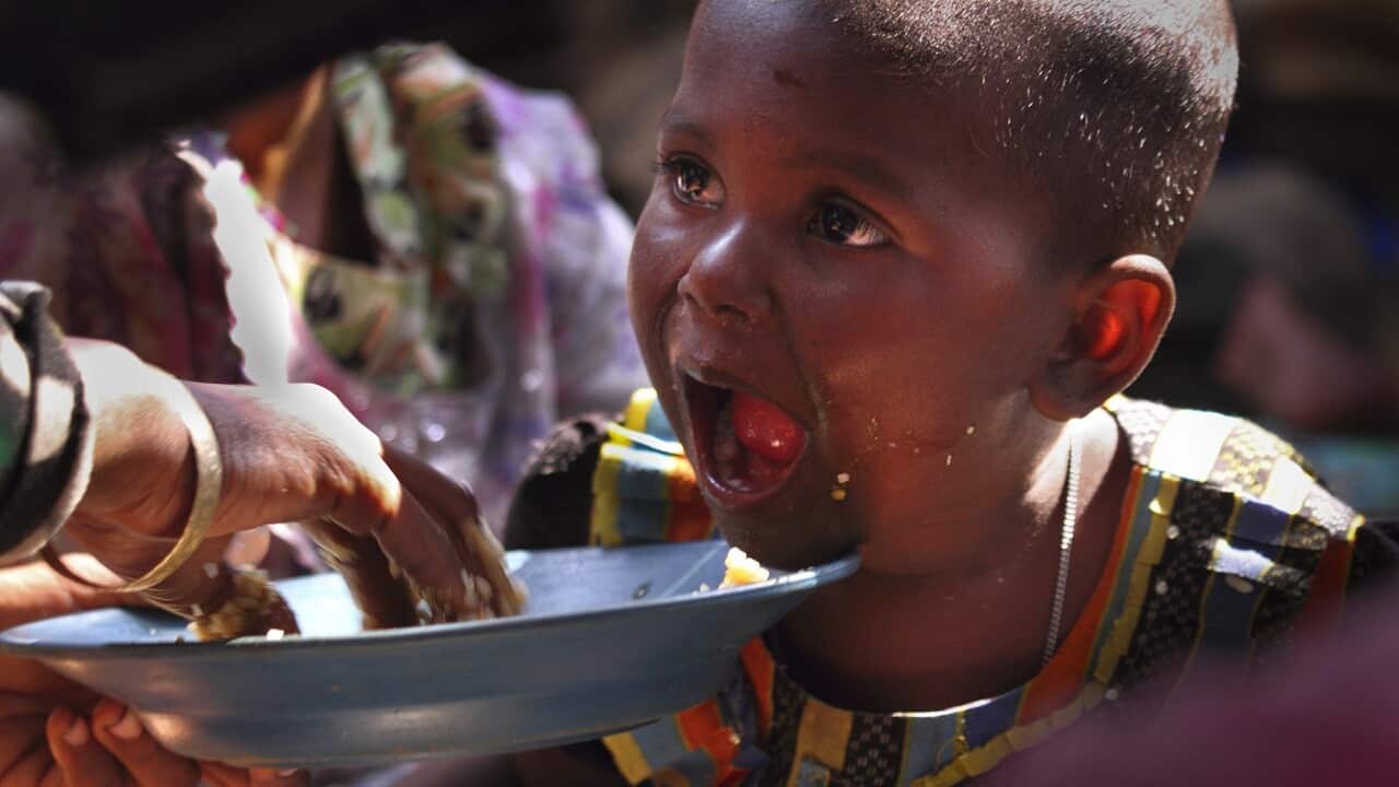 A newly arrived Rohingya refugee mother feeds her daughter at a transit camp in Nayaprar refugee camp near Cox's Bazar, Bangladesh.