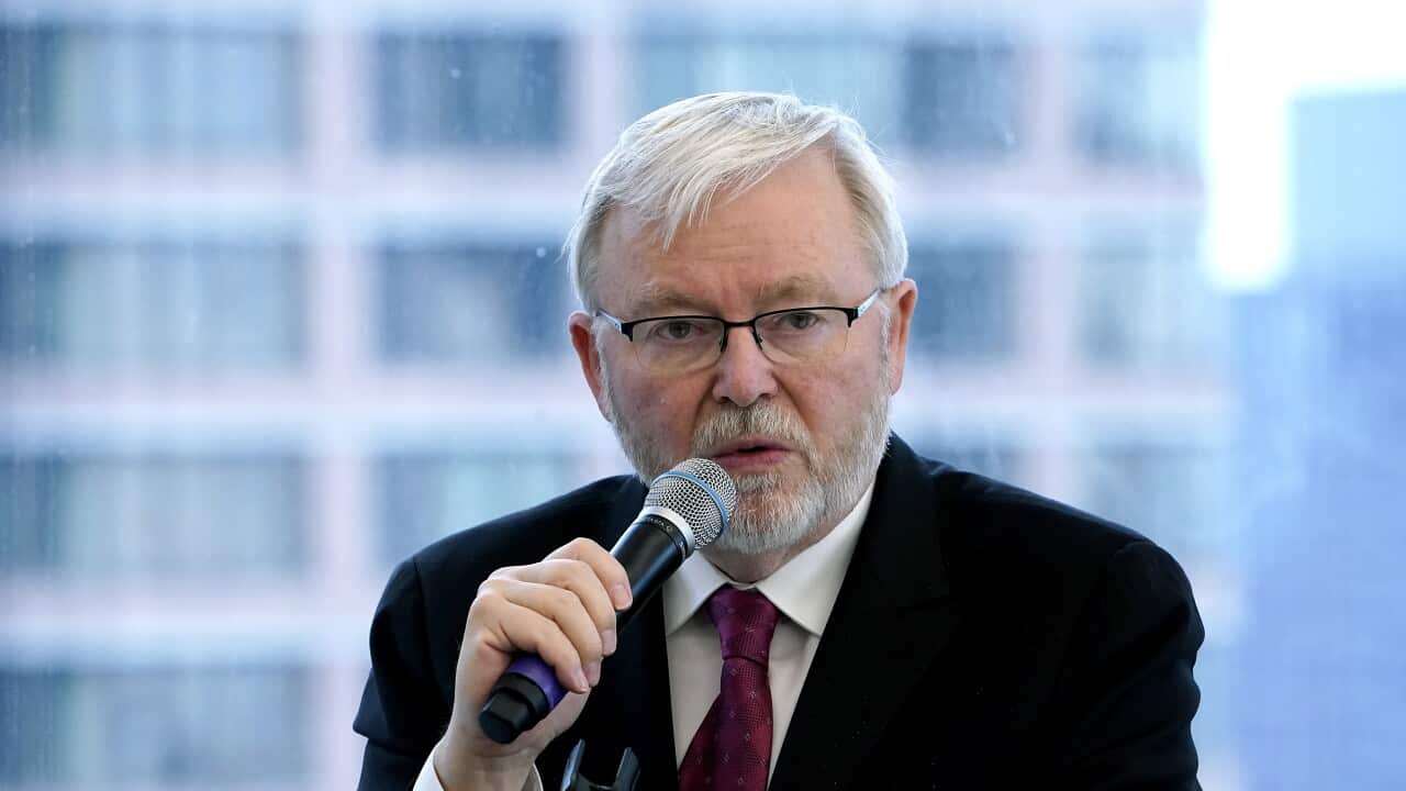 Kevin Rudd, wearing a suit and tie, speaking into a microphone.