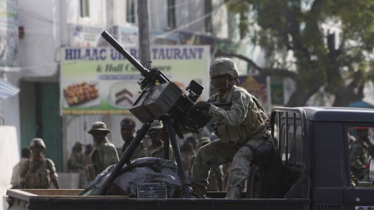 A Somali soldier takes position during fighting with militants.