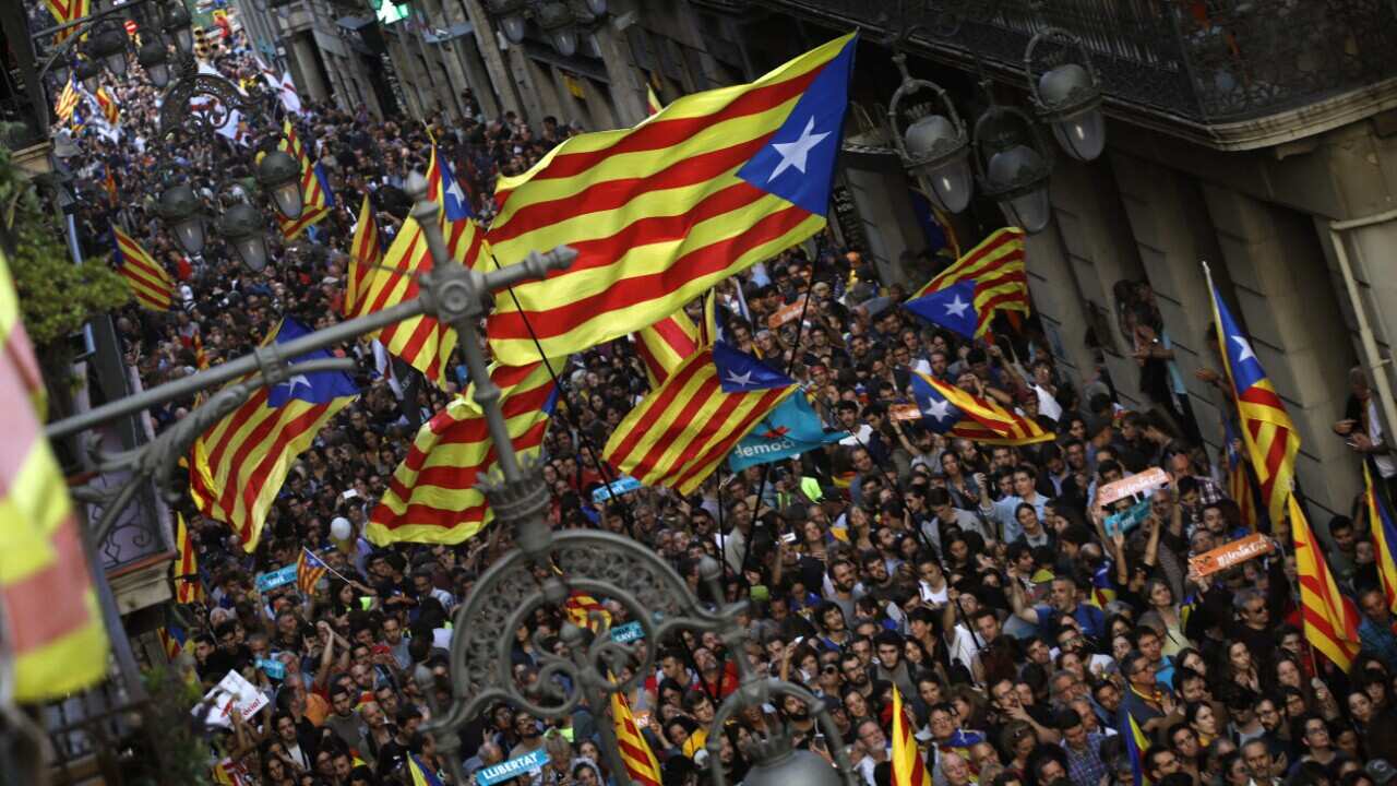 Pro-independence supporters gather near the Palau Generalitat in Barcelona, Spain, after Catalonia's regional parliament passed a motion with which they say they are establishing an independent Catalan Republic