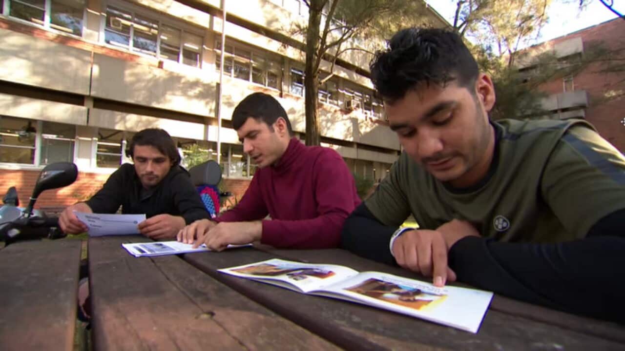 Abdul Wali Ahmadzai (left), Reyaz Talash and Aminullah Arsalan (right) are studying English at TAFE