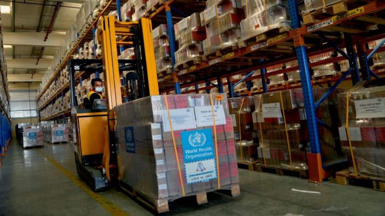 A forklift driver loads healthcare materials to be sent to Afghanistan at a UNHCR warehouse