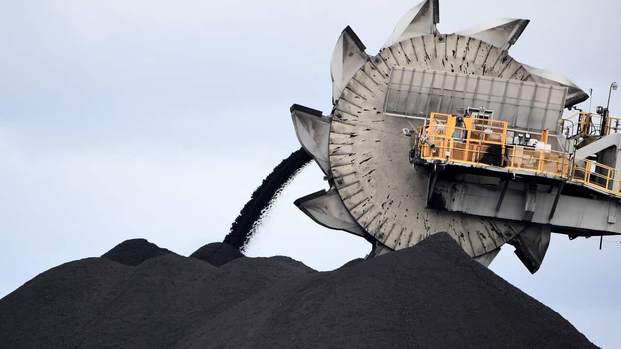 This picture taken on November 5, 2021 shows a bucket-wheel dumping soil and sand removed from another area of the mine in Newcastle, the world's largest coal exporting port.