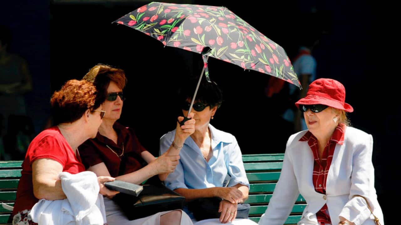 Women take refuge from the heat at Circular Quay in Sydney