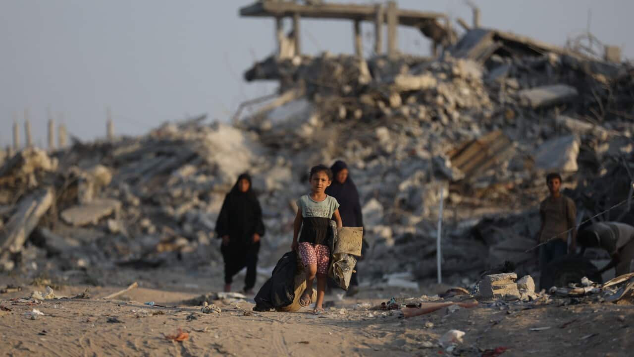 A child walking through the ruins of Gaza