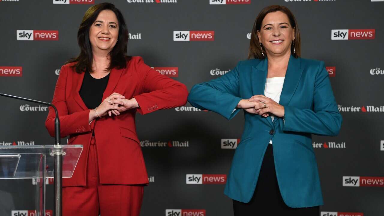 Queensland Premier Annastacia Palaszczuk (left) and opposition Leader Deb Frecklington bump elbows at the start of a People's Forum at the Broncos Leagues club in Brisbane, Wednesday, October 28, 2020. 