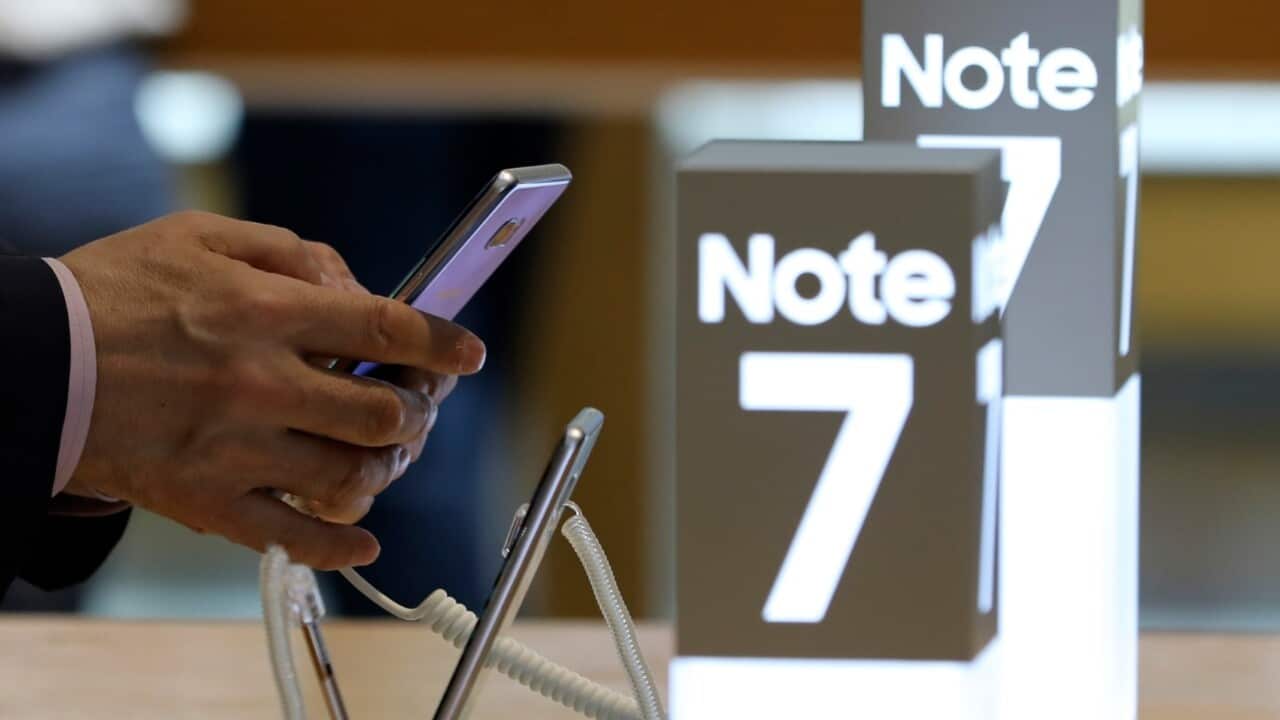  In this photo taken on Wednesday, Oct. 5, 2016, a man touches the Samsung Electronics Galaxy Note 7 smartphone at its shop in Seoul, South Korea.