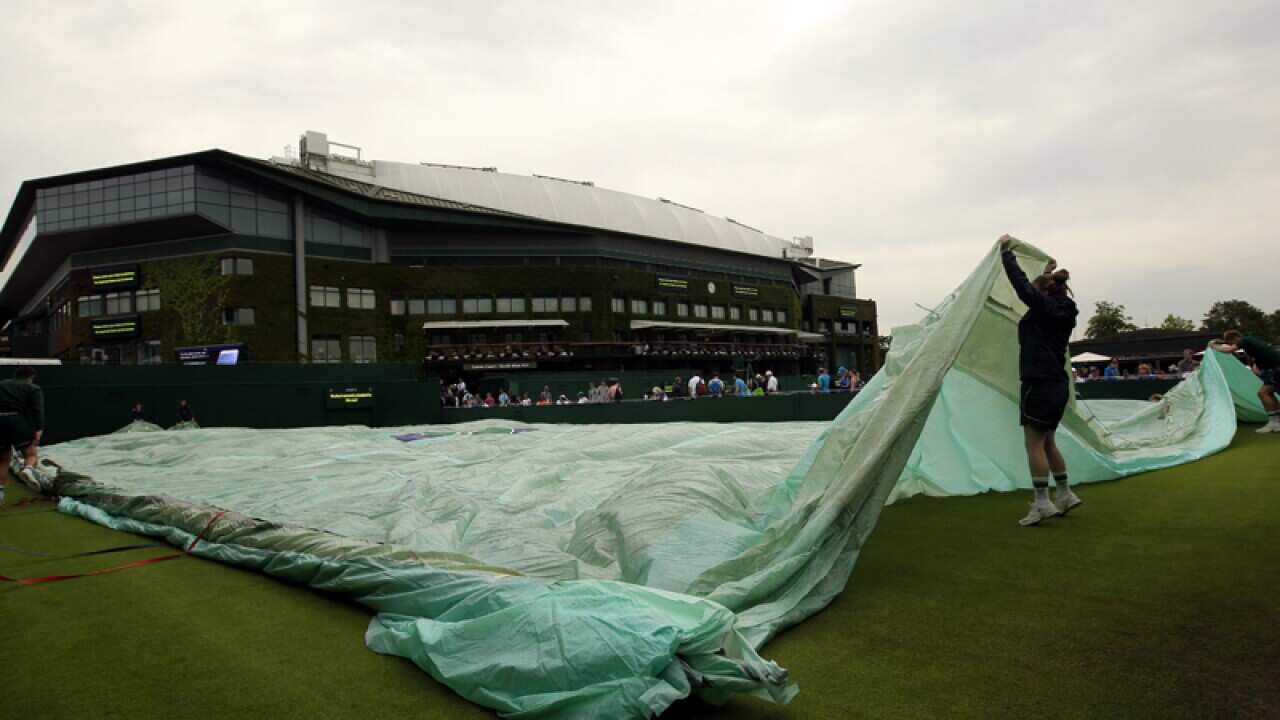 Rain stops play on court during the Wimbledon Championships
