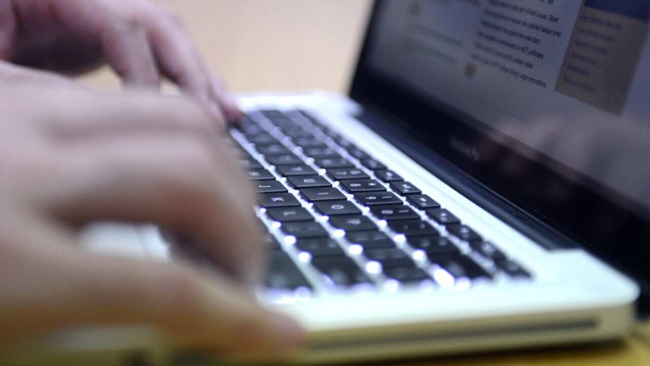 A man uses a laptop computer