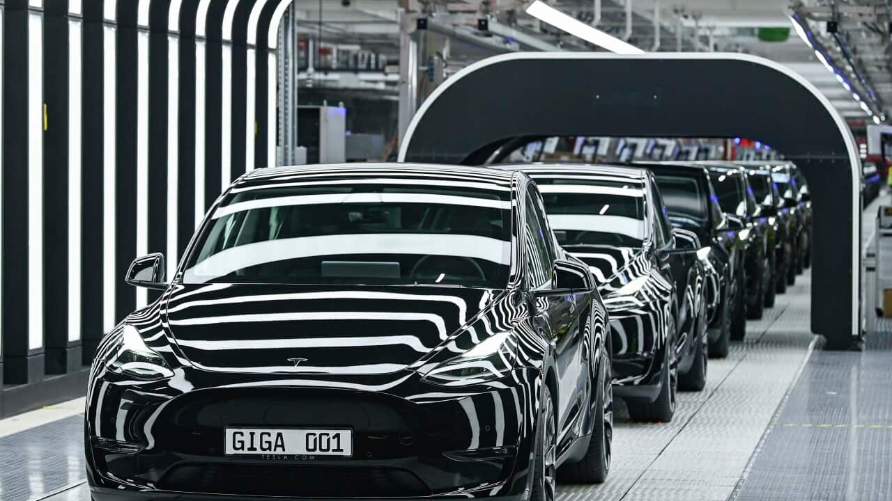 Model Y electric vehicles stand on a conveyor belt at the opening of the Tesla factory in Berlin Brandenburg in Gruenheide, Germany, Tuesday, March 22, 2022. The first European factory in Gruenheide, designed for 500,000 vehicles per year, is an important