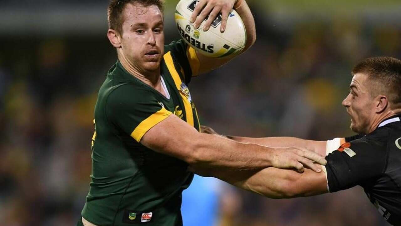 Michael Morgan of the Kangaroos is tackled