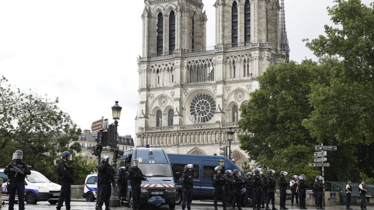 French police officers install a perimeter outside Notre Dame