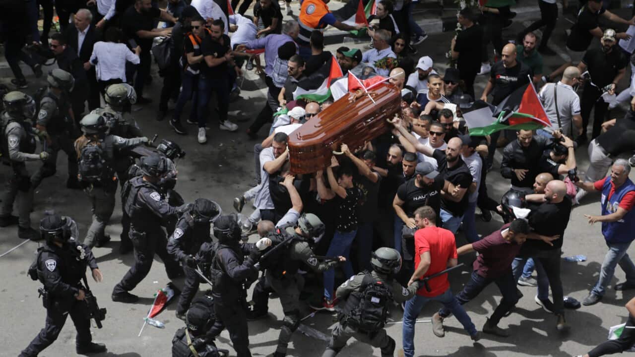 Israeli police confront with mourners as they carry the casket of slain Al Jazeera veteran journalist Shireen Abu Aqla during her funeral in east Jerusalem.