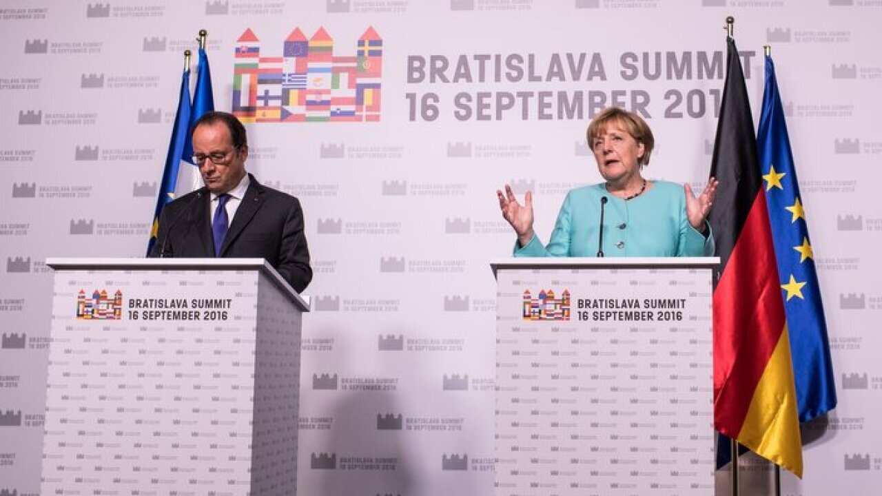 German Chancellor Angela Merkel (R) and French President Francois Hollande (L) adress the media during a press conference at the end of Bratislava EU summit.