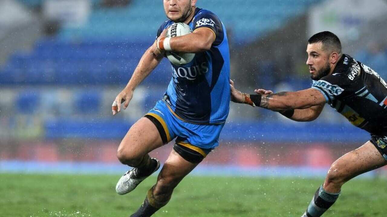 Titans player Ashley Taylor gets clear of Sharks player Jack Bird