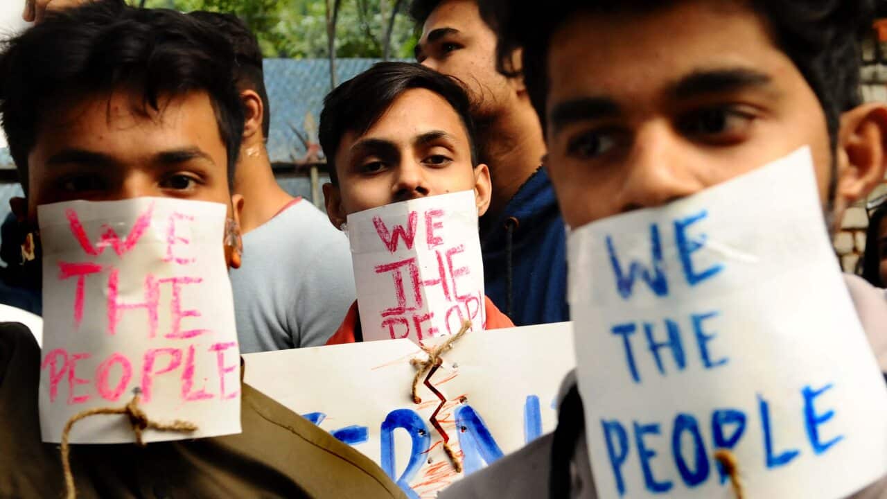 Protesters hold placards during a protest against the Citizenship Amendment Bill in New Delhi, India, on 14 December, 2019.