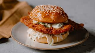 Crumbed barramundi burger with lime and black pepper slaw