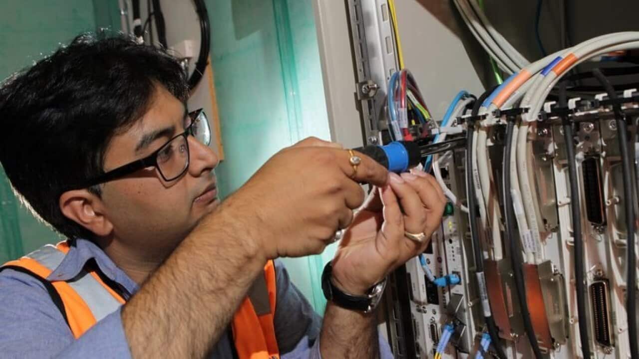 NBN technician connects an apartment block to the National Broadband Network (NBN) in Brunswick, Melbourne