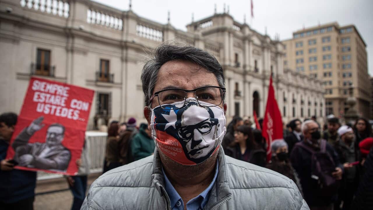 People gather outside the La Moneda Palace to commemorate Salvador Allende’s 1970 election victory in Santiago, Chile