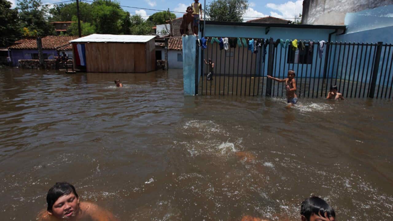 Some children swim in flood