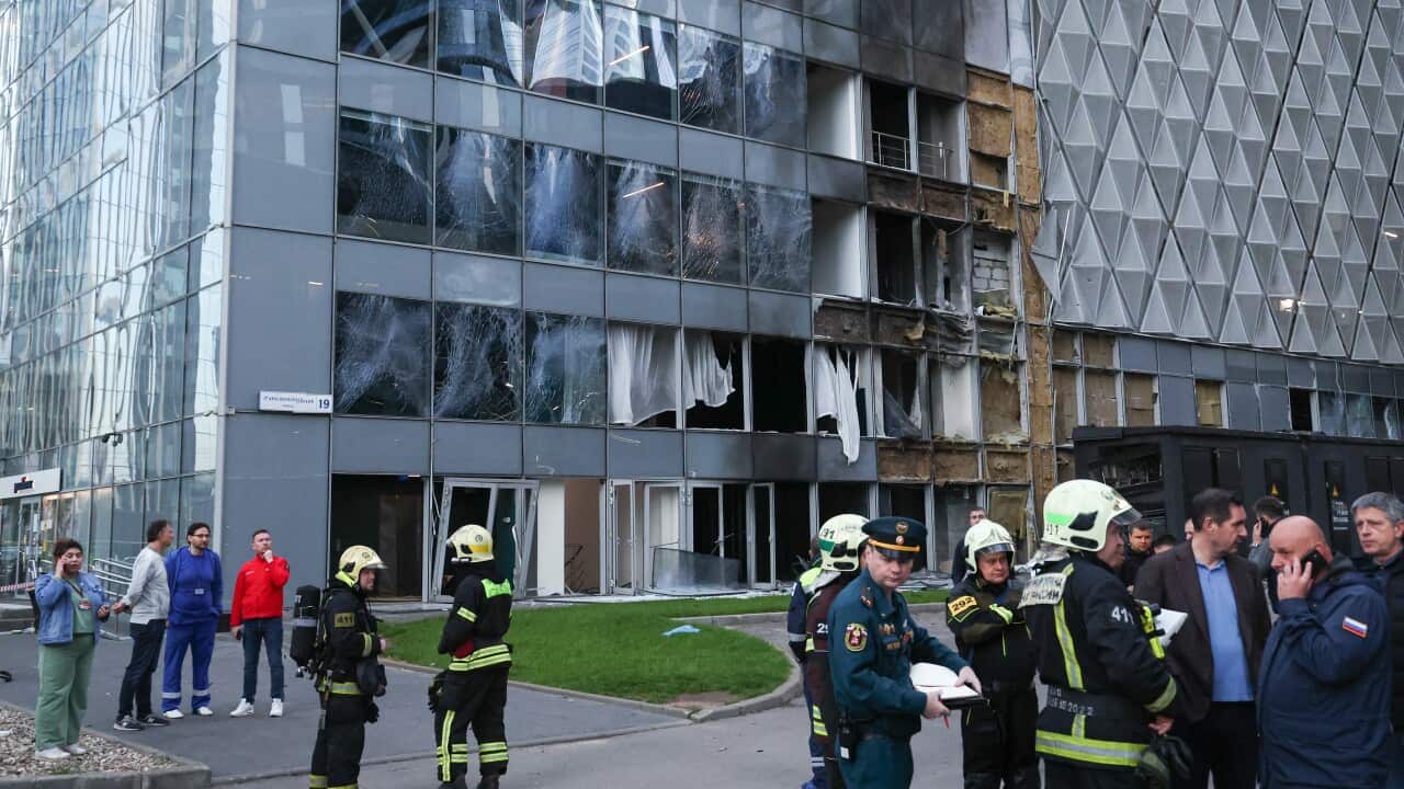 First responders are seen outside the Oko-2 tower at the Moscow International Business Centre (Moscow City) hit by an explosion.