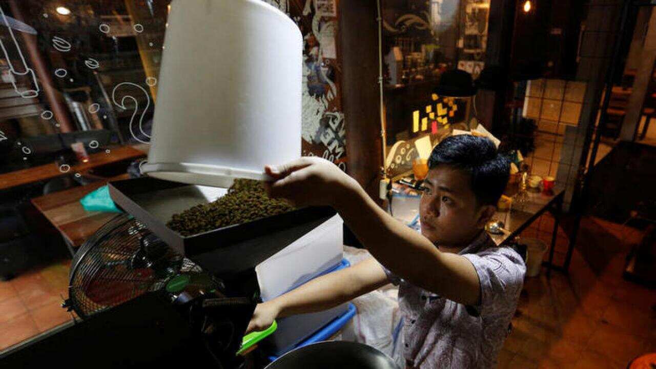 A worker prepares to roast locally grown coffee in Bandung, West Java.