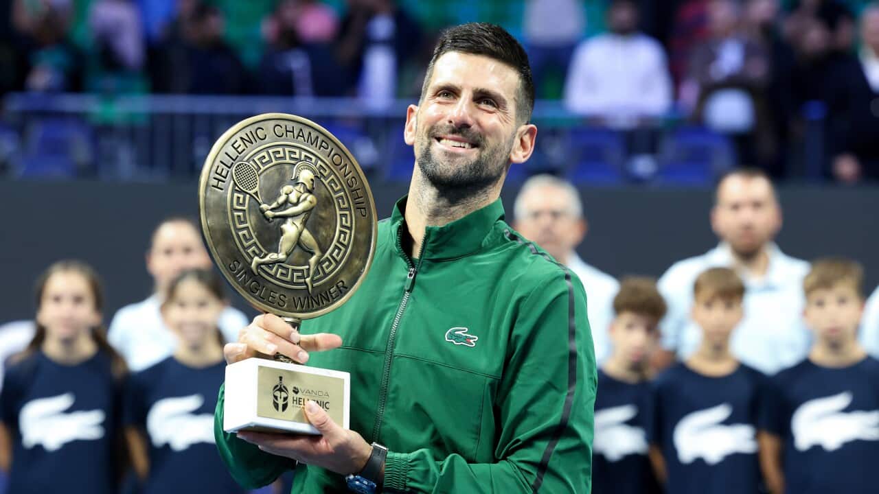 Novak Djokovic of Serbia raises the trophy of the ATP 250 tennis tournament after winning the final match against Lorenzo Musetti of Italy, in Athens, Greece, Saturday, Nov. 8, 2025. (AP Photo/Yorgos Karahalis)