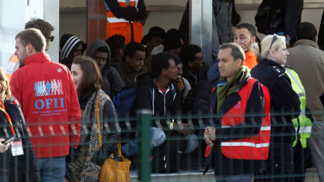 Unaccompanied minor migrants in Calais waiting to be transferred to camps elsewhere in France