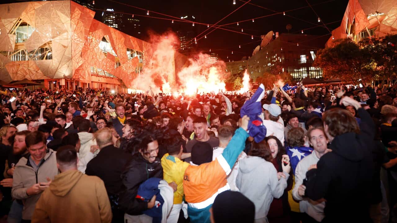Socceroos fans at Federation Square in Melbourne, celebrate goal scored by Australia against Denmark in the 2022 FIFA World Cup