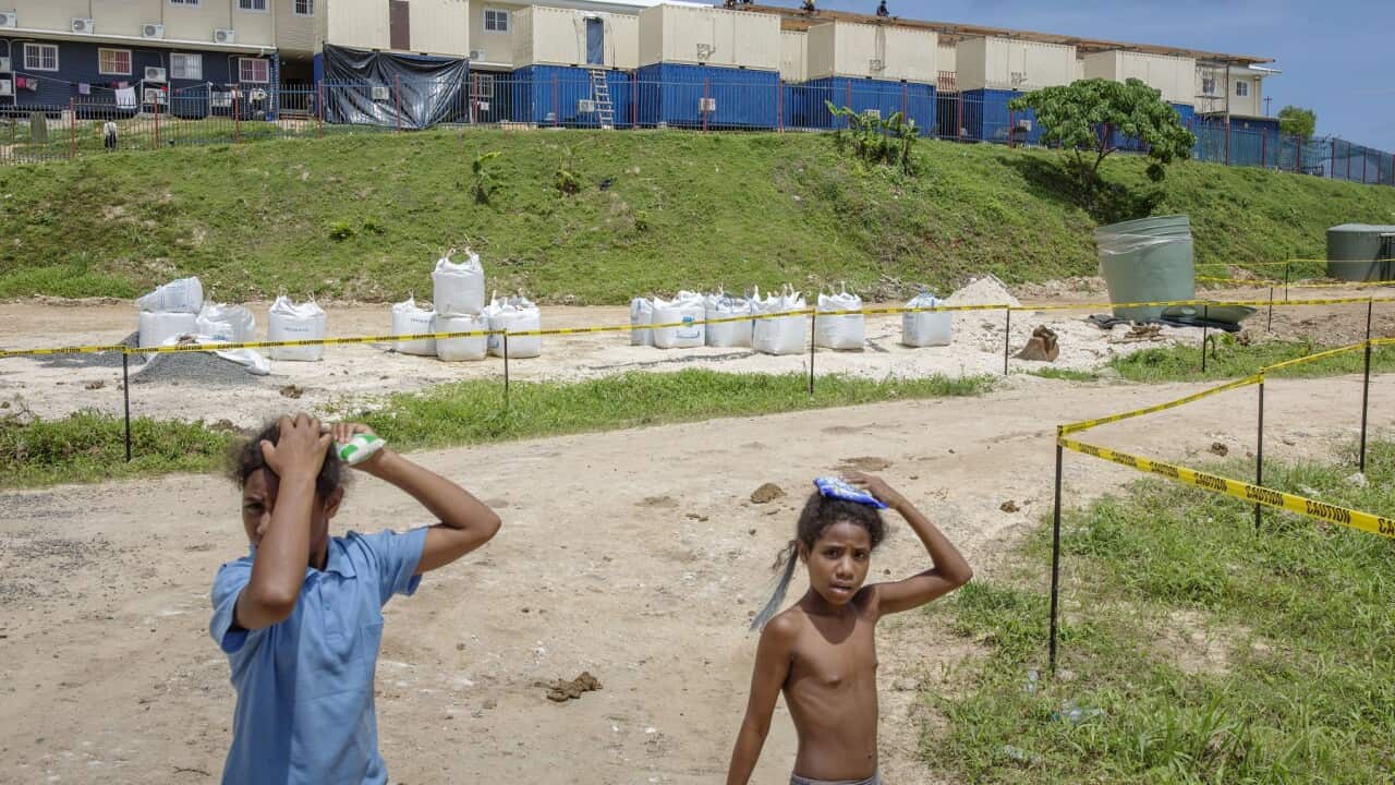 Children bypassing the barracks where asylum seekers are living on Manus Island