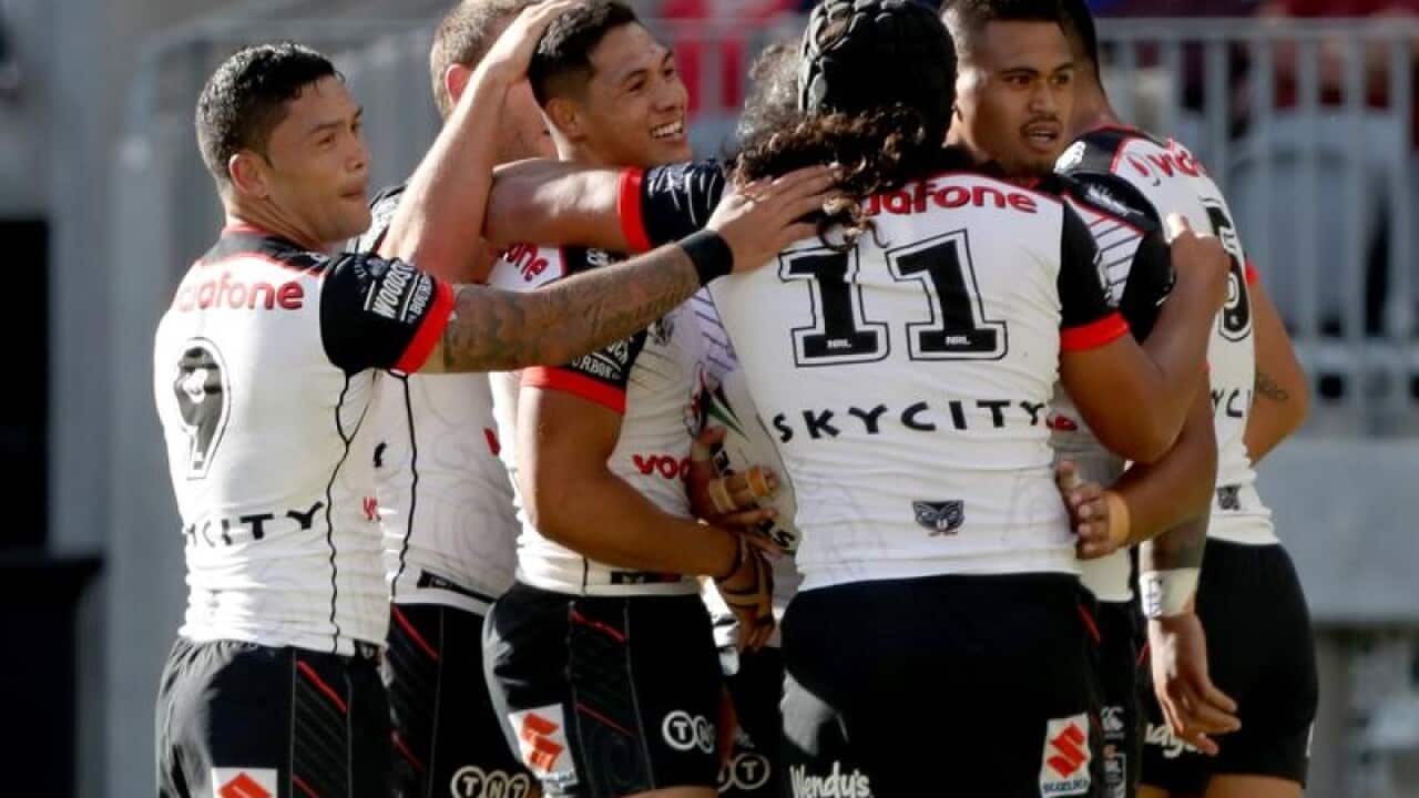 Warriors players celebrate after scoring a try