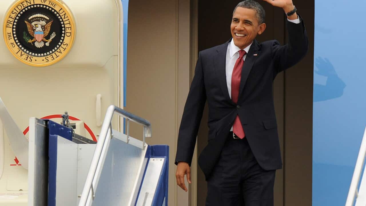 US President Barack Obama waves after arriving at Fairbairn Defence Establishment in Canberra. (Getty)