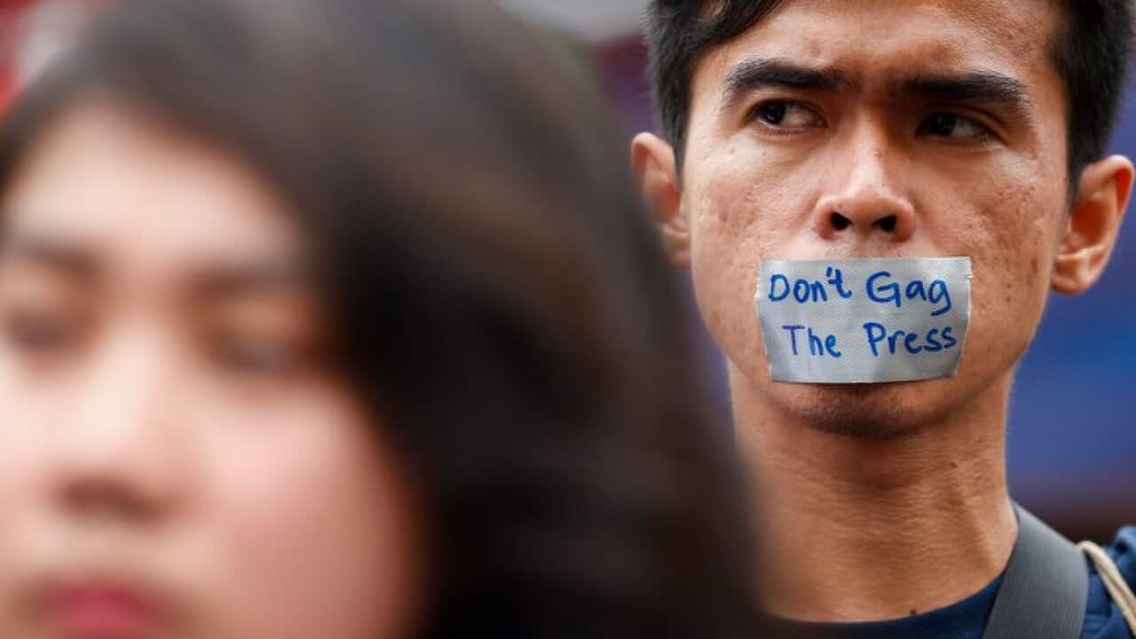 a man demostrates against media curtailment