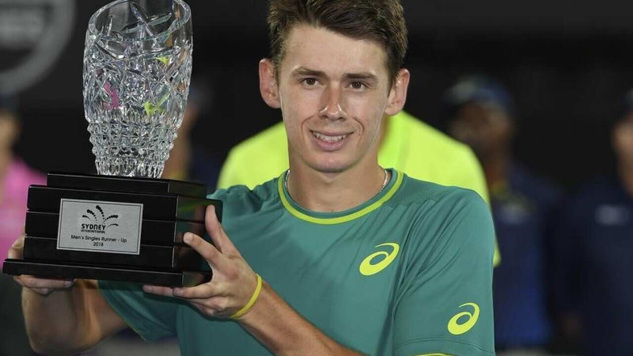 Alex de Minaur poses for a photograph with the runner-up trophy.